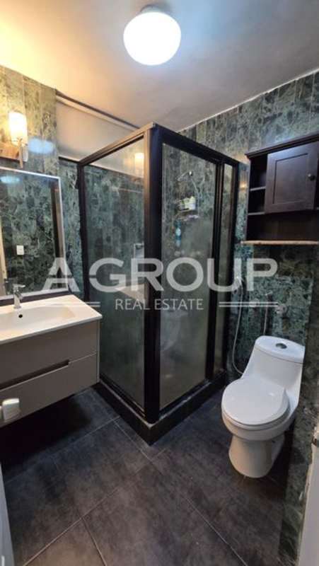 Marble-tiled bathroom with vanity, toilet, glass shower enclosure in PH Vizcaya Punta Paitilla Panama