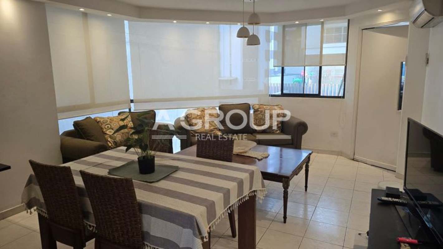 Contemporary open concept living and dining area with large windows and tile floors in PH Vizcaya Punta Paitilla