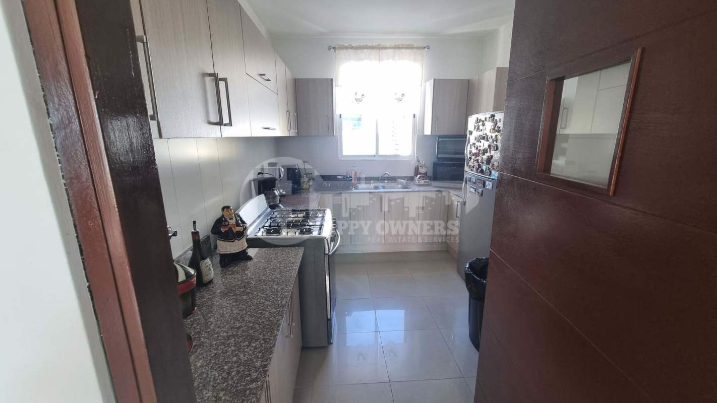 Kitchen with granite countertops, appliances and window lighting at PH Galeria Uno apartment Obarrio