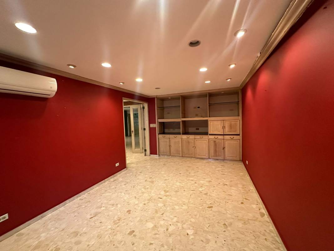 Living space with built-in wood cabinetry, marble floor, recessed lighting commercial rental Obarrio Panama