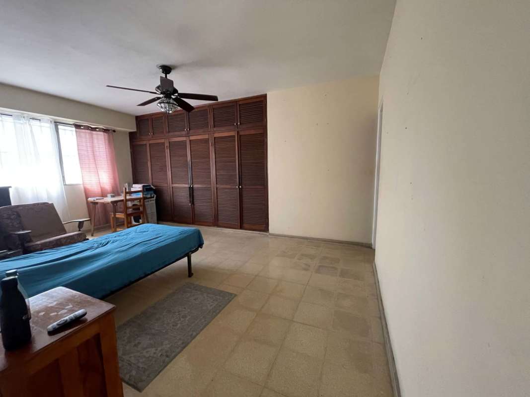 Dining room with glass display cabinet ceiling fan and large windows in PH Altamar apartment Panama
