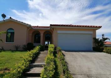 Double garage Mediterranean home facade red tile roof Hacienda Pacifica Panama