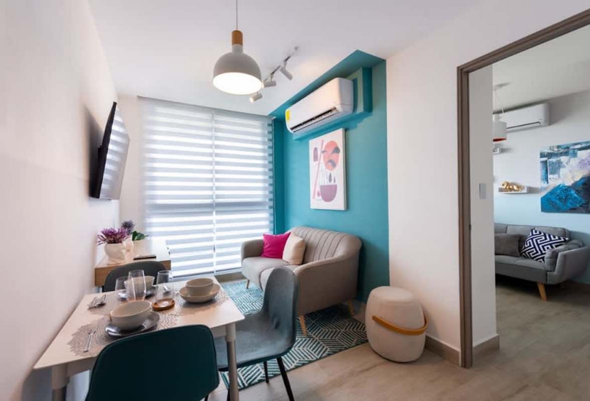 Bright living room with ceramic tile floors, large window and access to balcony in PH GreenWood Panama City