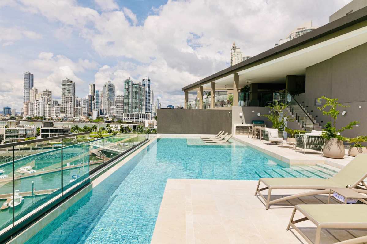 Elegant open concept living and dining area with large windows and marble floors in Ocean Reef Casa del Mar Panama