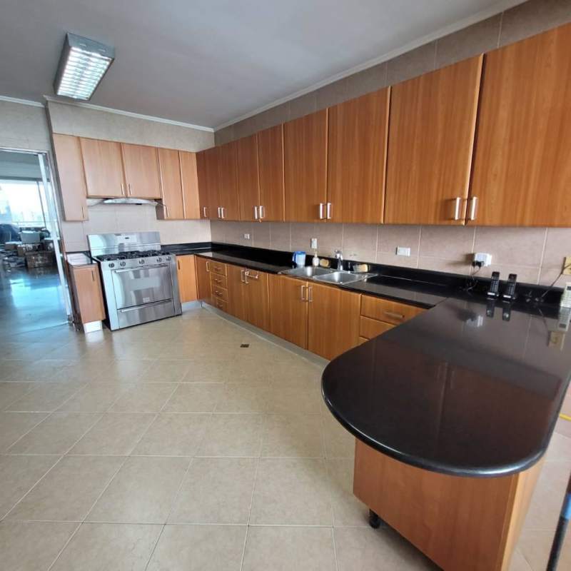 Luxury dining area with glass table, marble floors, and floor-to-ceiling windows in PH Peninsula Panama