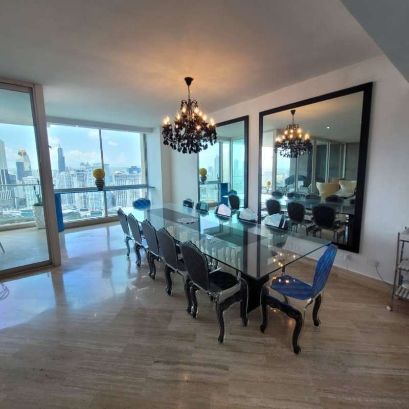 Contemporary kitchen featuring black granite countertops and wood cabinetry at PH Peninsula Punta Paitilla