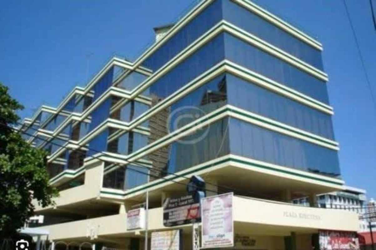 Modern commercial office building with reflective glass windows in Plaza Ejecutiva Panama City