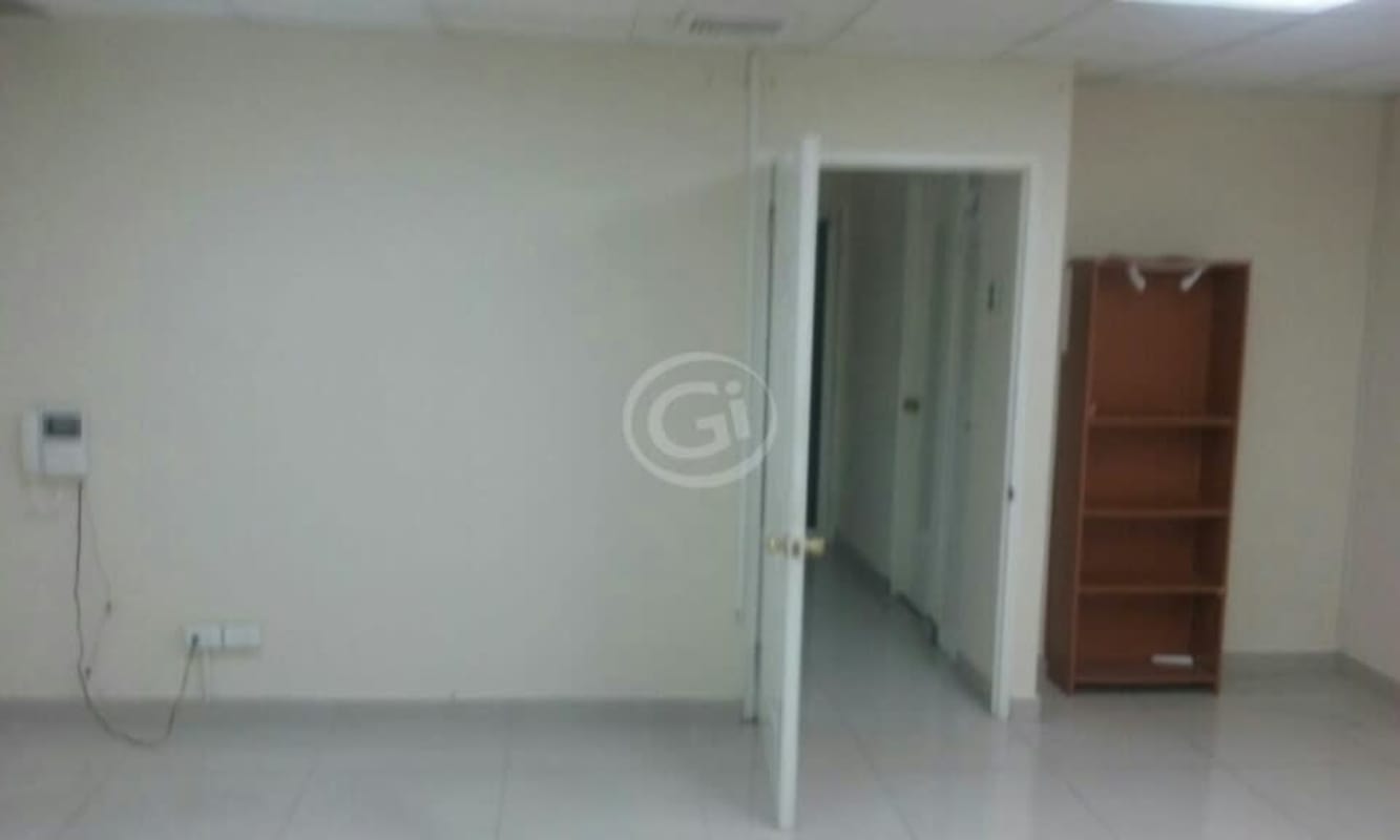 Vacant commercial office room with tiled floors and beige walls in Bella Vista Panama