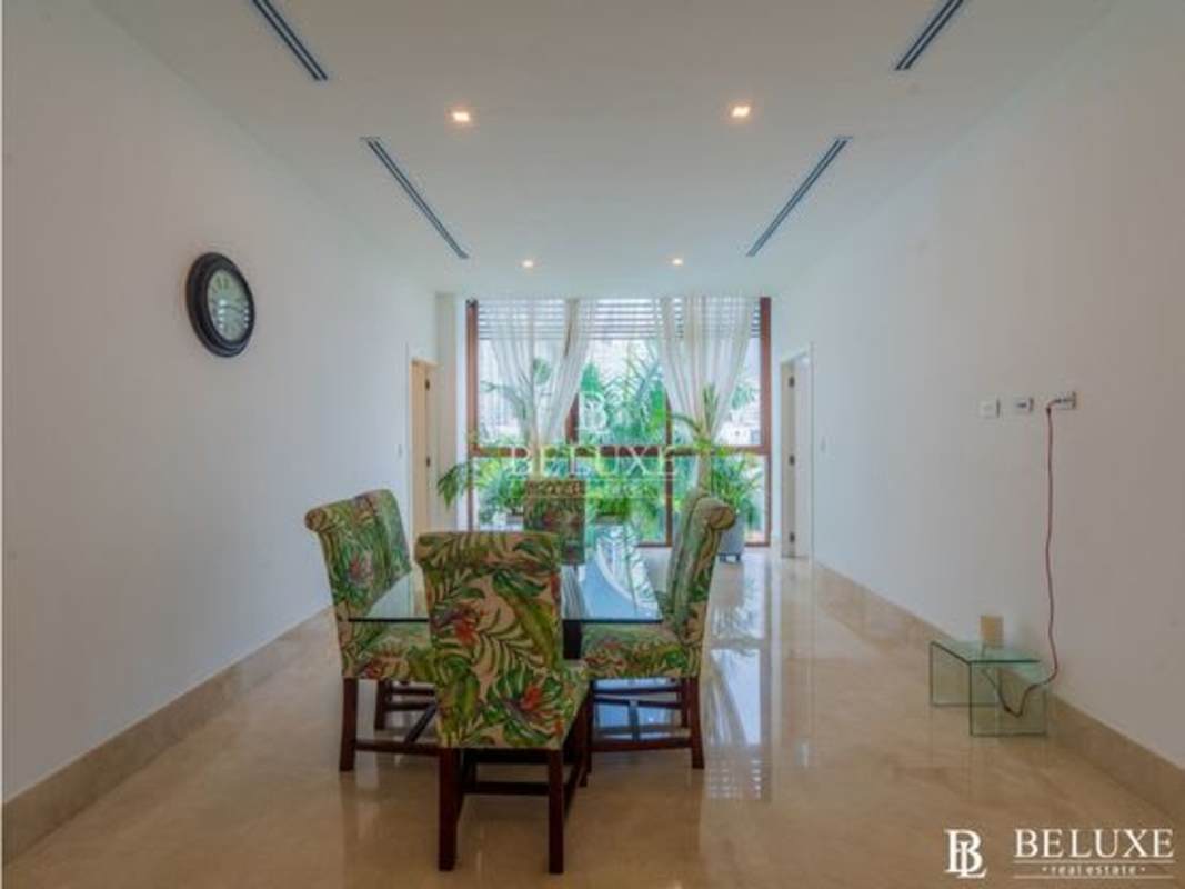 Elegant dining room with marina views, luxury furniture and porcelain floors at Ocean Reef apartment