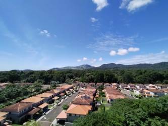 Aerial suburban Panama Pacifico tiled roof houses and mountains