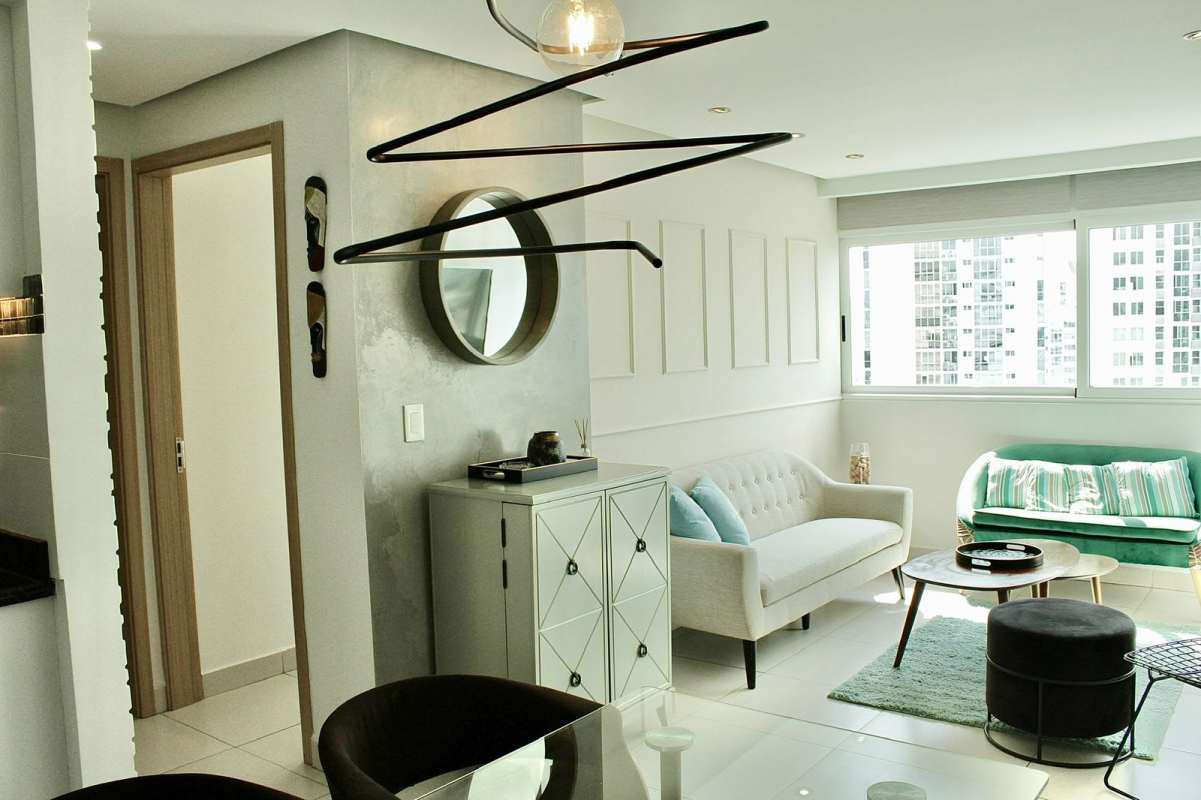 Living room with large windows, natural light, contemporary furniture and city view in PH Moderno Carrasquilla Panama
