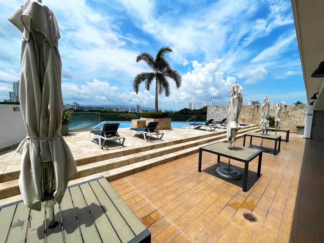 Rooftop infinity pool with sun loungers and panoramic city skyline in PH Moderno next to Parque Omar Panama