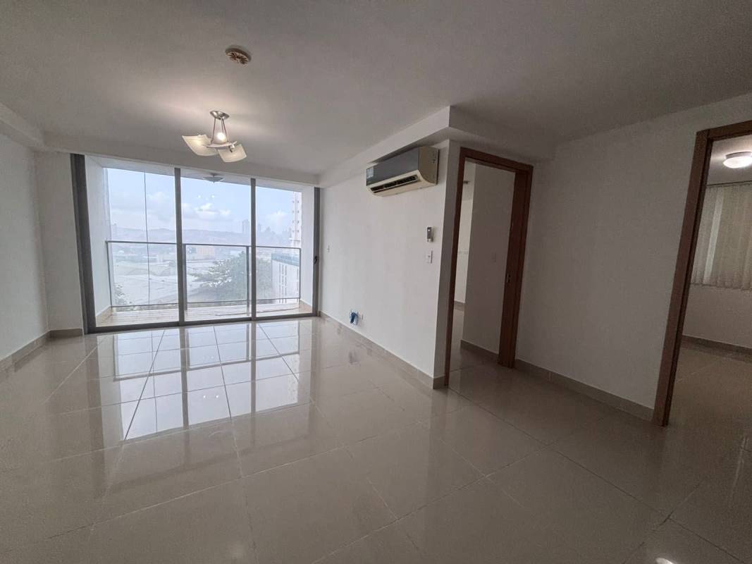 Spacious living room connected to modern kitchen in Torres de Castilla apartment Carrasquilla Panama