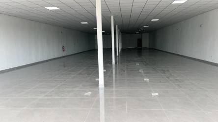 Street view of commercial plaza with multiple storefronts and balcony in Costa Verde Colón Panama