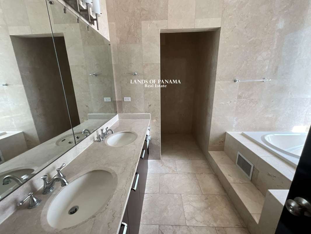 Modern marble bathroom with jacuzzi tub and glass shower in Pacific Point apartment Panama