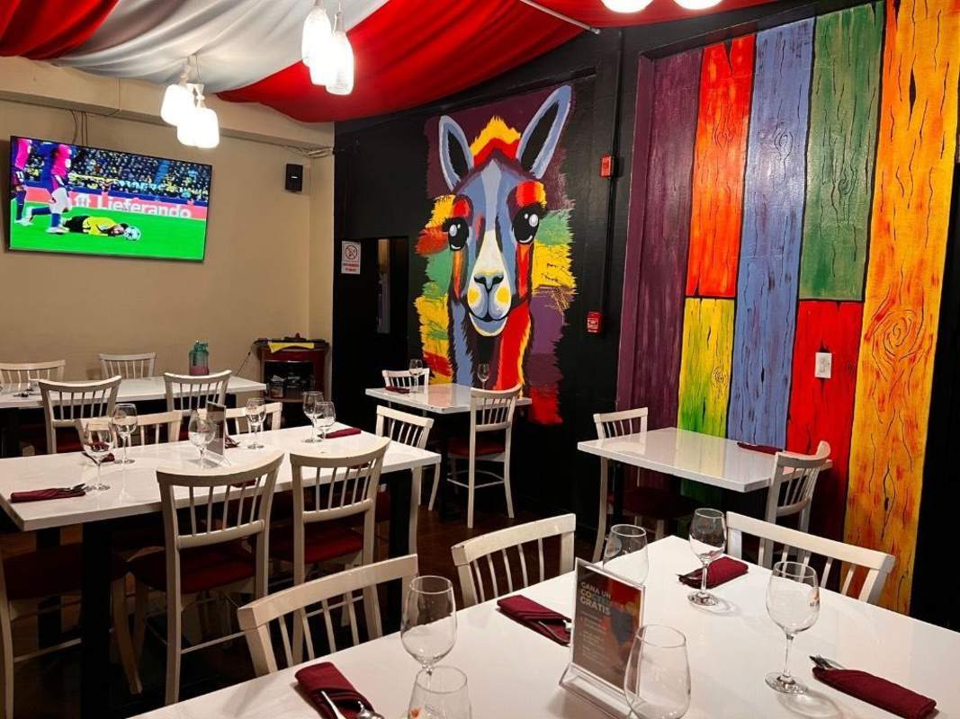 Restaurant dining space with artistic murals, ceiling drapery, seating Obarrio