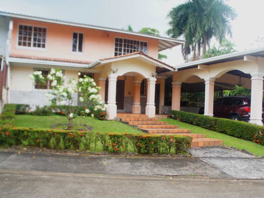 Two story Mediterranean style house in Los Rios with arched porch, landscaped yard and driveway