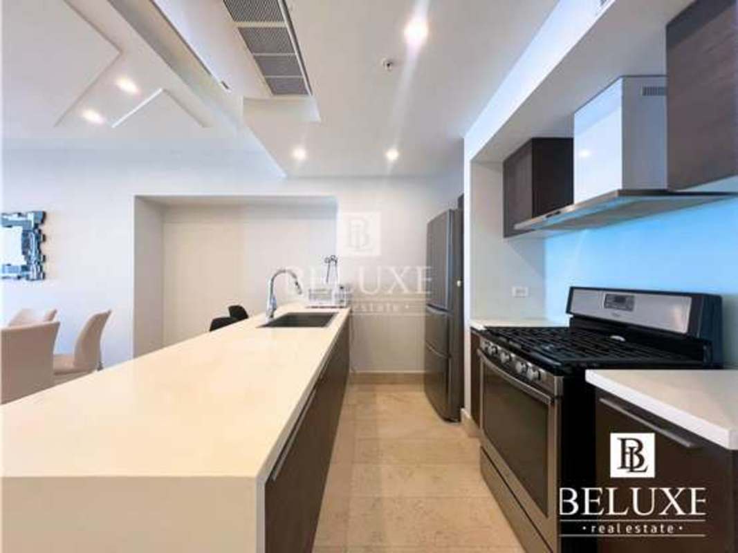Spacious kitchen with island, stainless appliances and stylish design in PH YOO