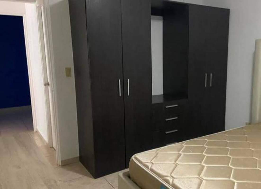 Minimalist bedroom with wardrobe, beige mattress and tile floors in PH Metro Tower Panama City