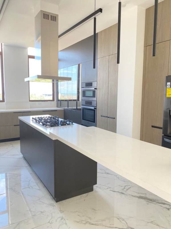 Spacious master bedroom with large windows and ocean views in luxury penthouse Ocean Reef Islands Panama