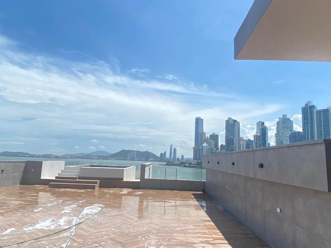 Luxury living room with floor-to-ceiling windows overlooking Pacific Ocean and skyline Ocean Reef Islands