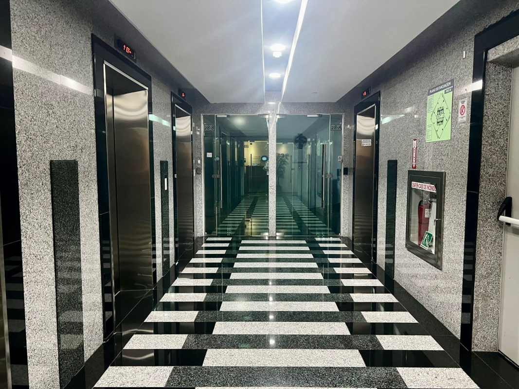 Modern lobby with granite walls and elevators at F&F Tower Panama