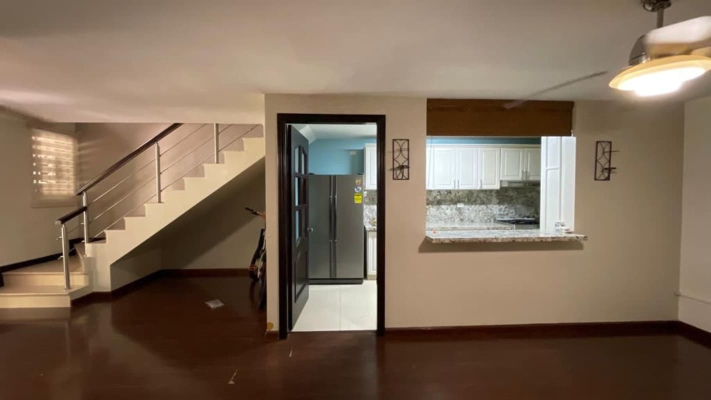 Cozy bedroom featuring wood floor AC built-in closet in Condado del Rey house Panama