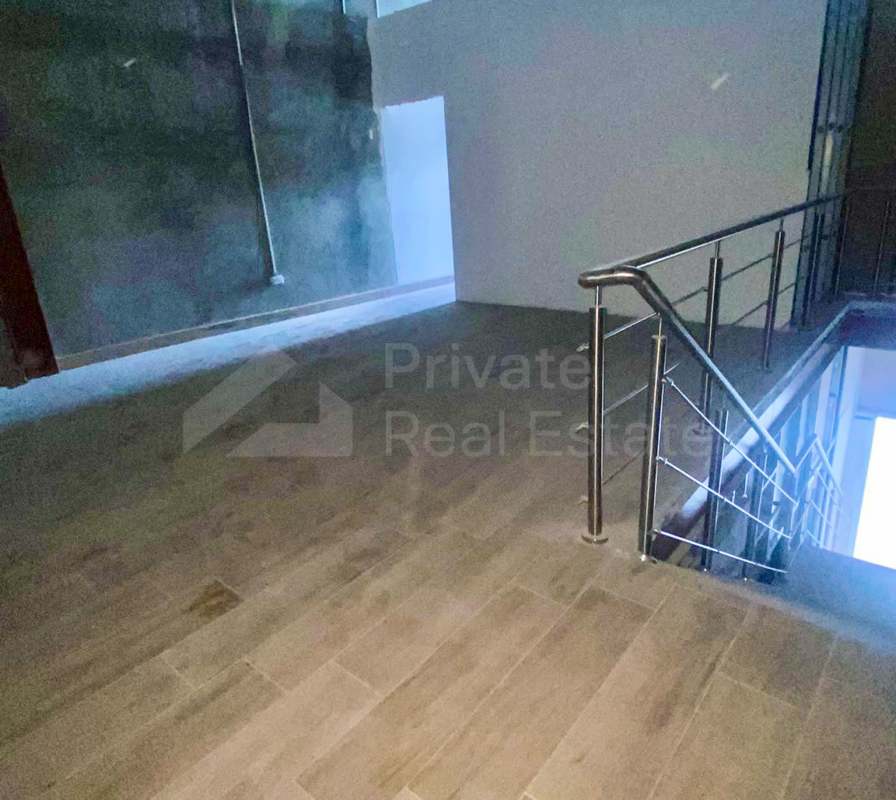 Unfinished commercial interior with staircase and stainless steel railings in Midtown Plaza Panama City