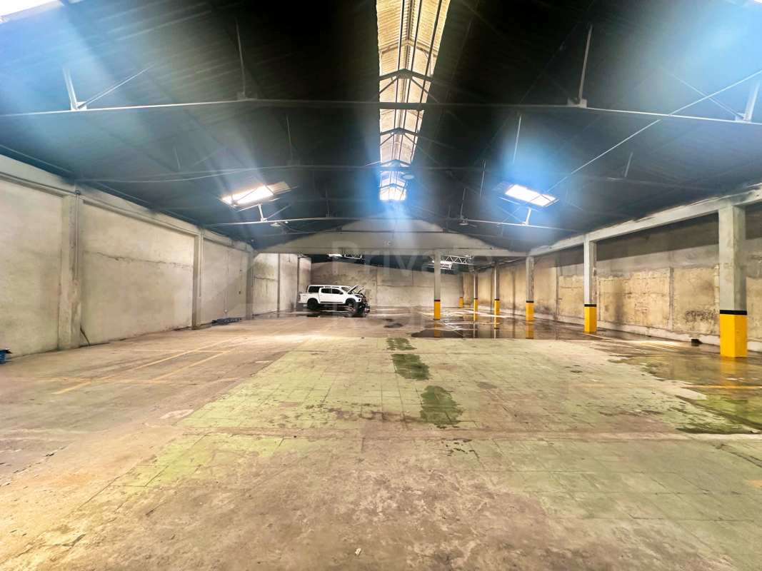 Warehouse inside view concrete floors steel beams vehicle space in Betania Panama