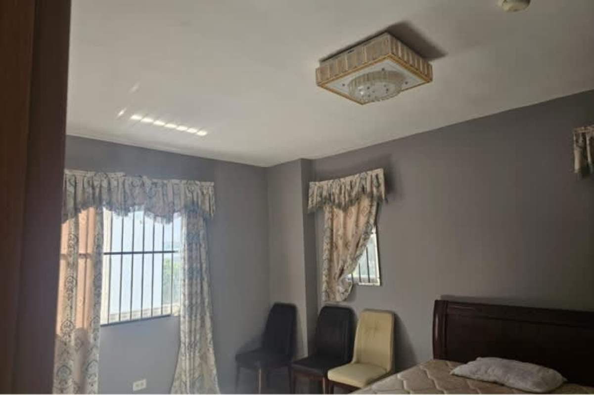 Bedroom with gray walls large windows curtains AC connection rental house Brisas del Golf Panama