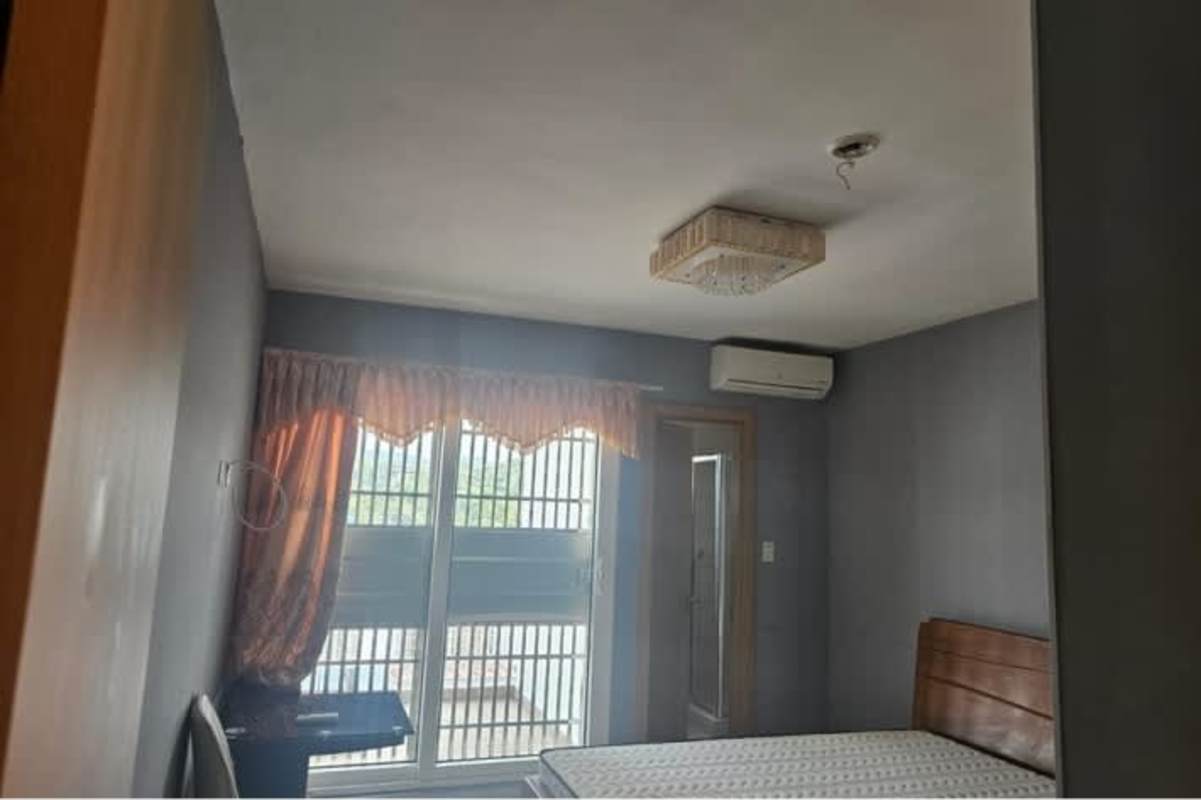 Bedroom window security bars tiled floor air conditioning hook Panama rental home