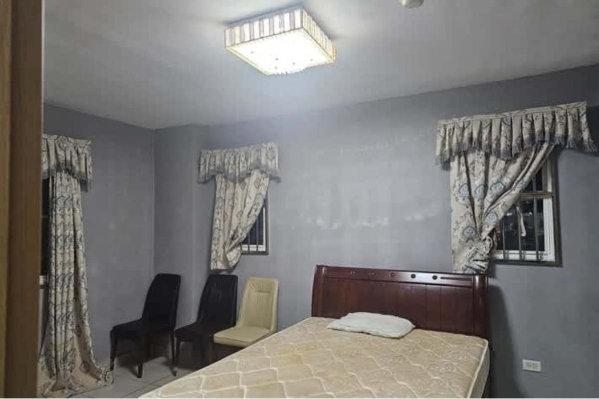 Bedroom with tile floor curtains window security bar AC ready Brisas del Golf Panama