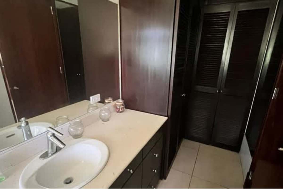 Spacious master bedroom with sliding doors, wood beams, AC unit, garden view in Ancón house Panama City