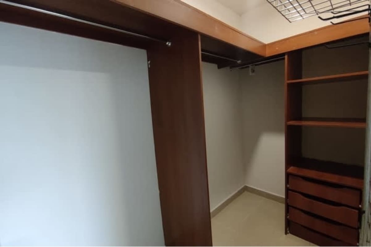 Spacious walk-in closet with wooden shelves in furnished apartment PH San Francisco Bay Panama