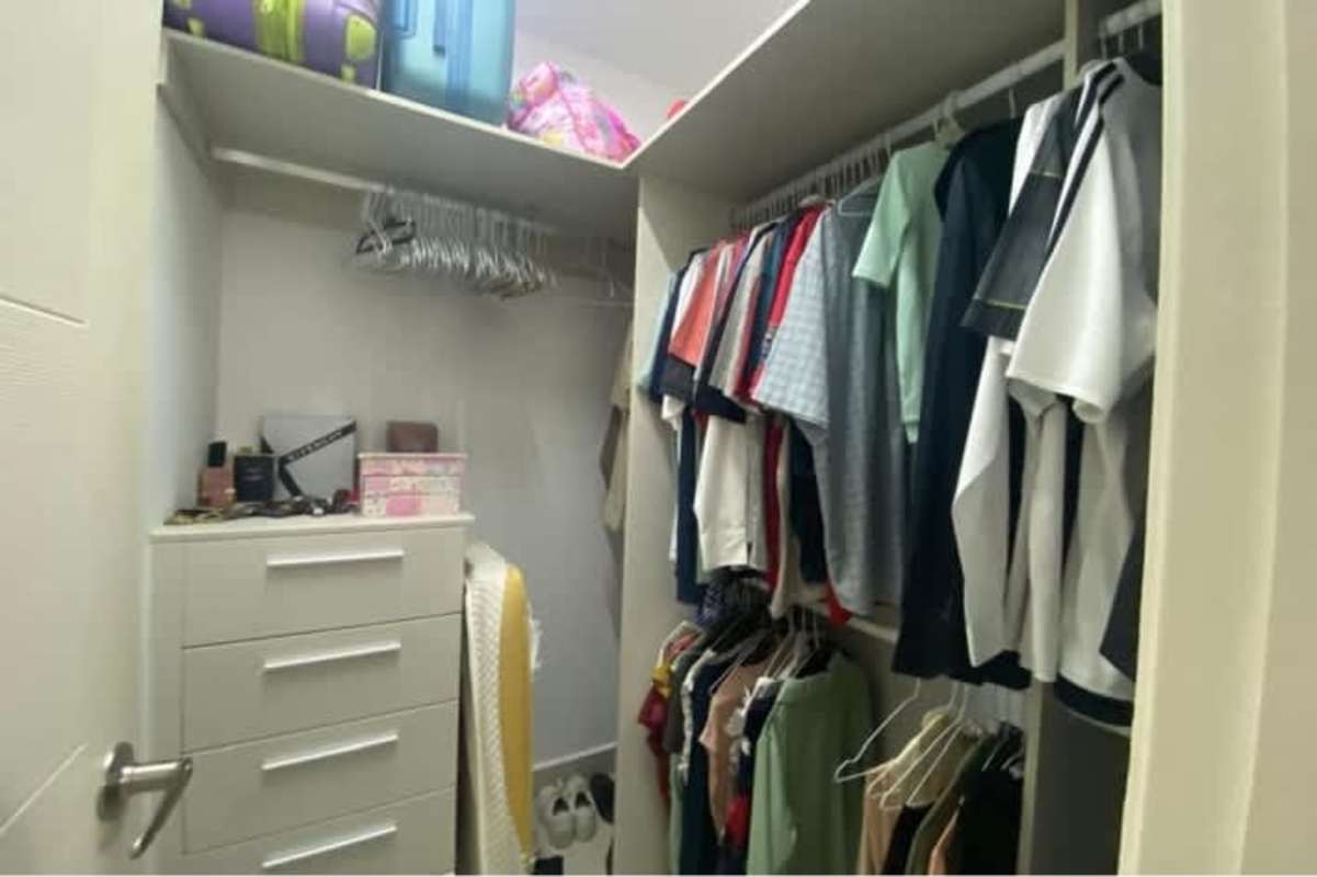 Secondary bedroom with closet and large window in apartment in Brisas del Golf Panama