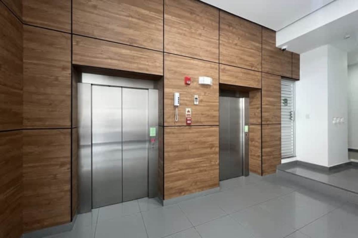Elegant lobby area with two stainless elevators and wood panel in PH Calidonia Panama City