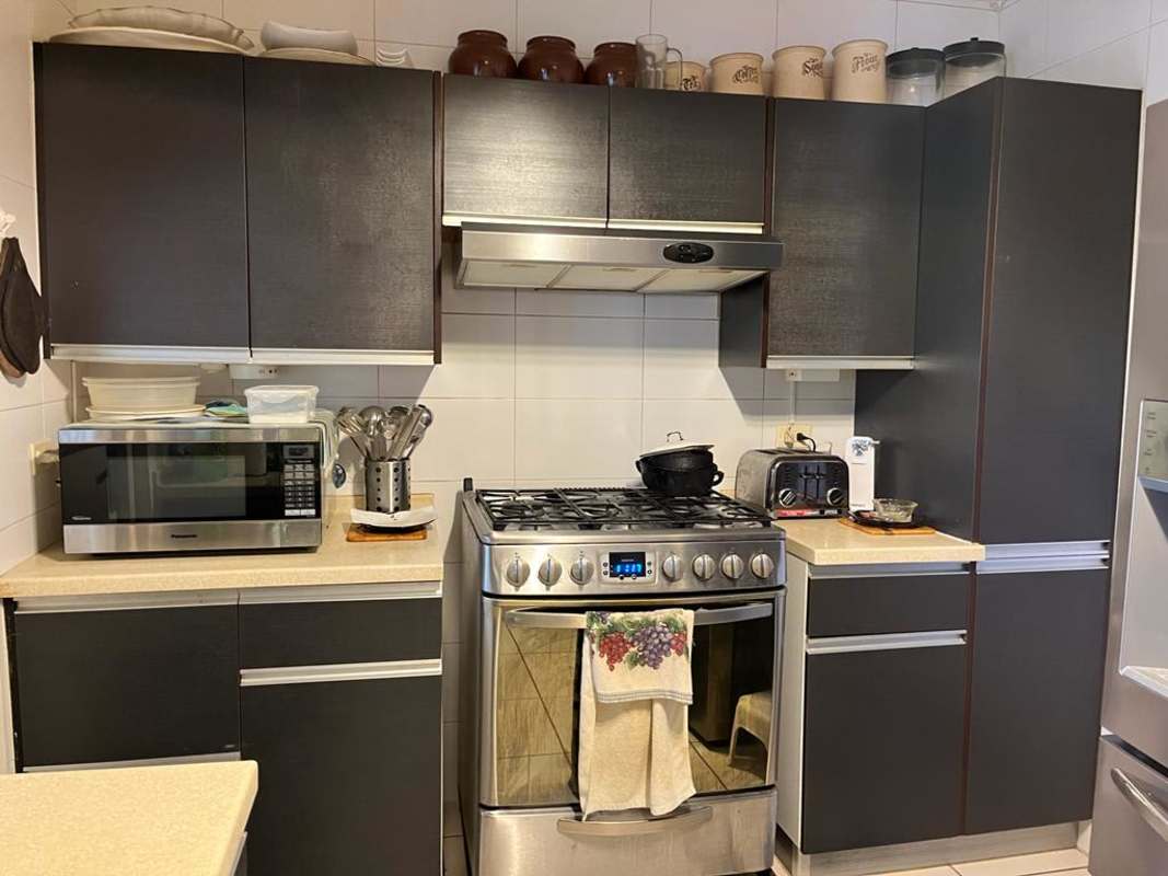 Modern open living area with tile floors, patio access in duplex home PH Augusta