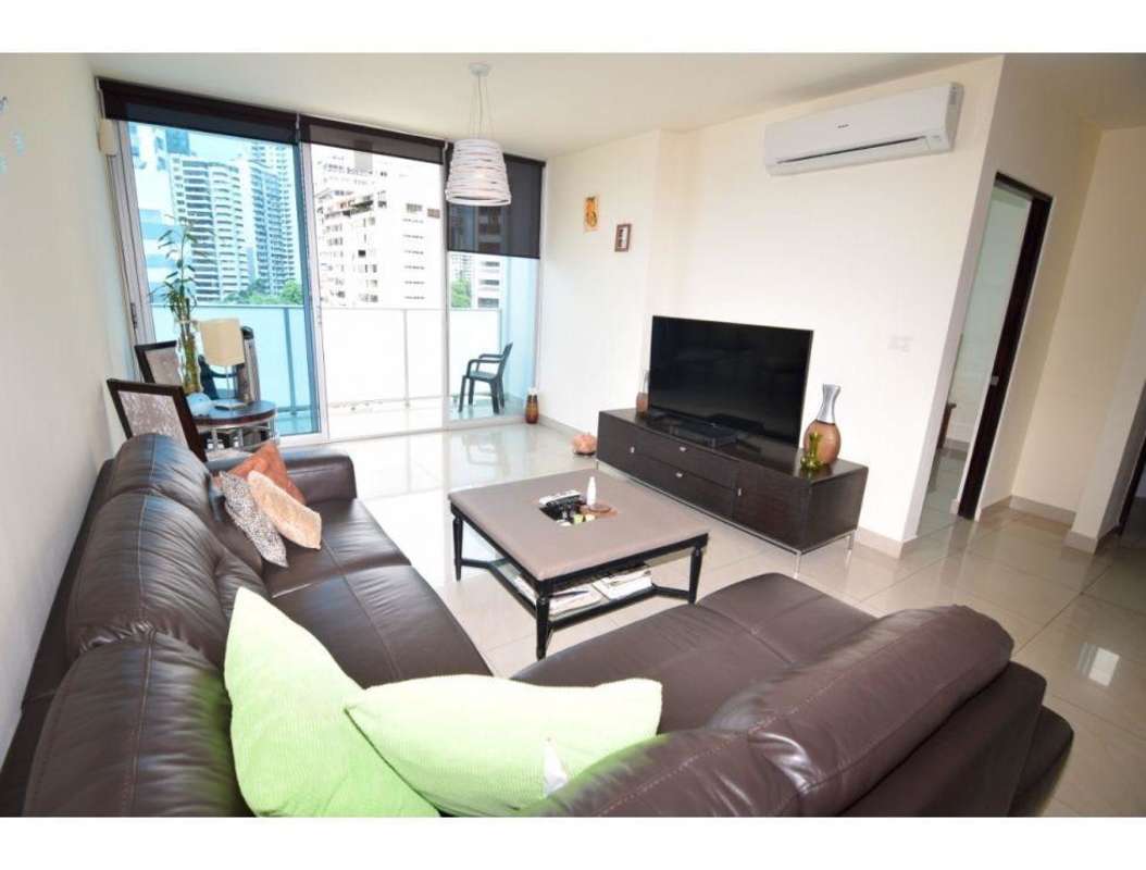 Bright living room with large sliding doors to balcony with ocean and skyline views in PH Pacific Sky Panama