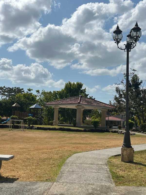 Bedroom interior with closet, large window and tiled floor at Brisas del Golf house in Panama