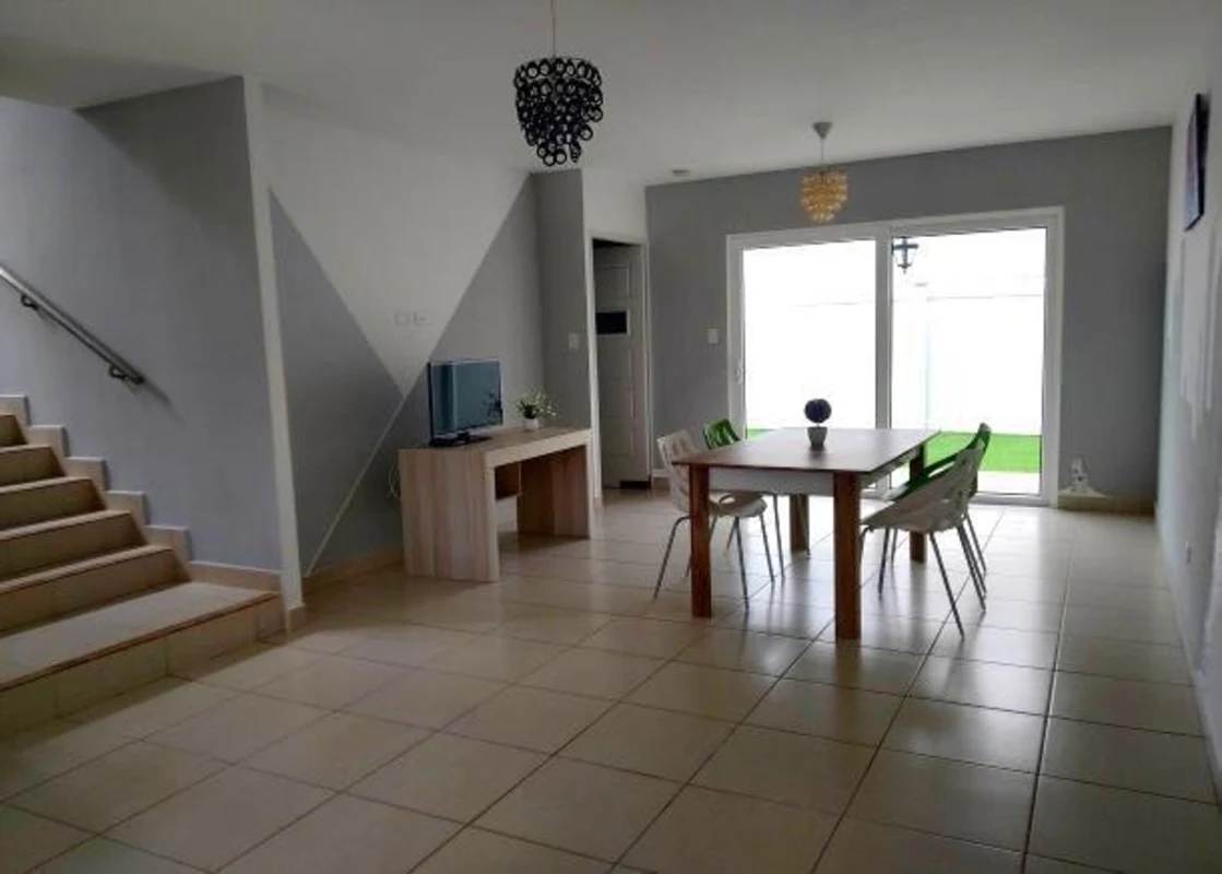 Open plan living-dining with natural light and patio access PH Augusta