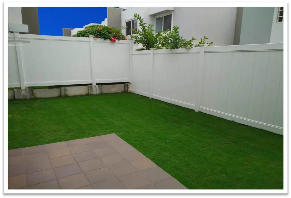 Fenced backyard with grass and patio tiles in PH Augusta Paseo del Norte