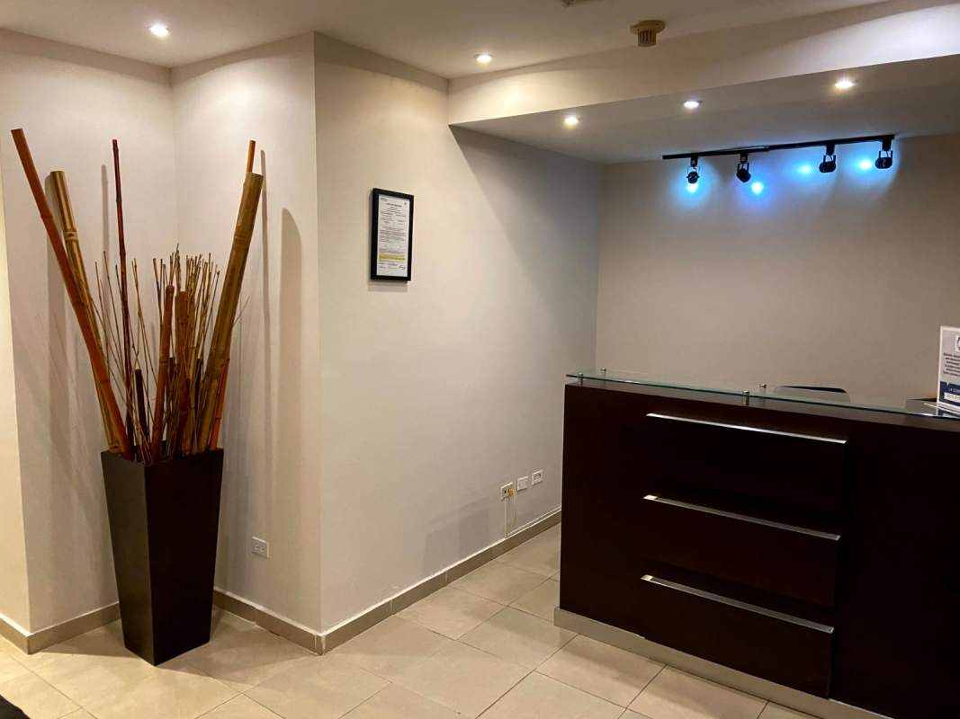 Meeting room with conference table, screen, and blue chairs for sale office in Hi Tech Plaza