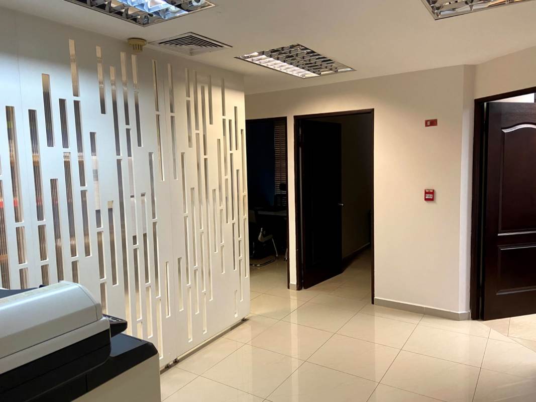 Contemporary hallway with tile floor, blue accent walls and filing storage in PH Hi Tech Plaza Obarrio