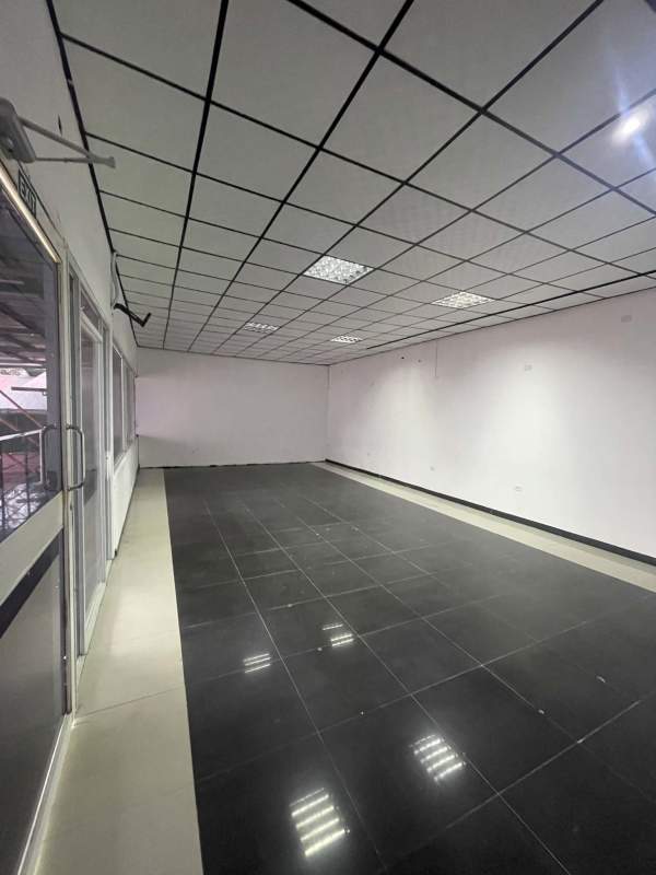 Hallway leading to commercial space entrance with tiled floor Midpoint Plaza Panama City