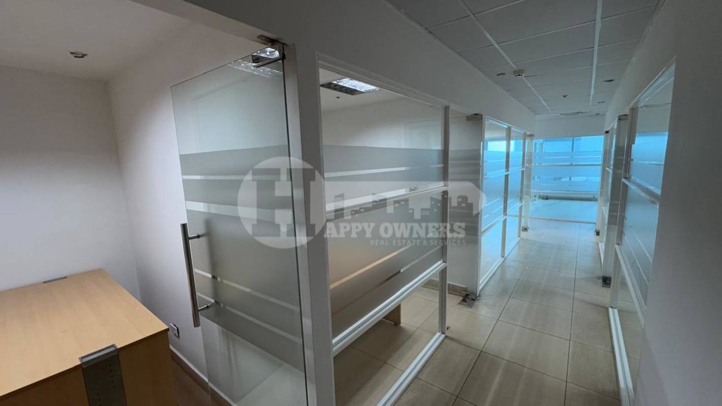 Interior corridor with frosted glass cubicles in premium commercial office Torre Banesco Panama City