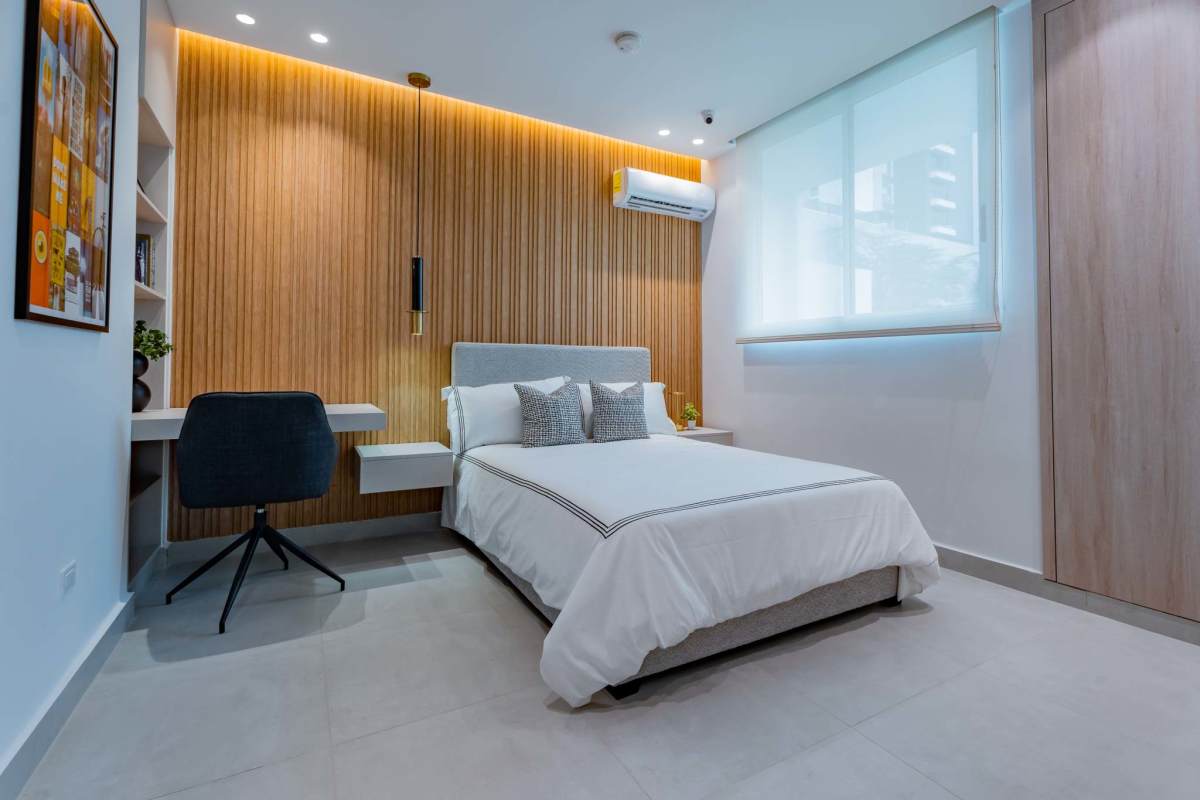 Cozy modern bedroom with large window natural light at Condado Gardens Panama City