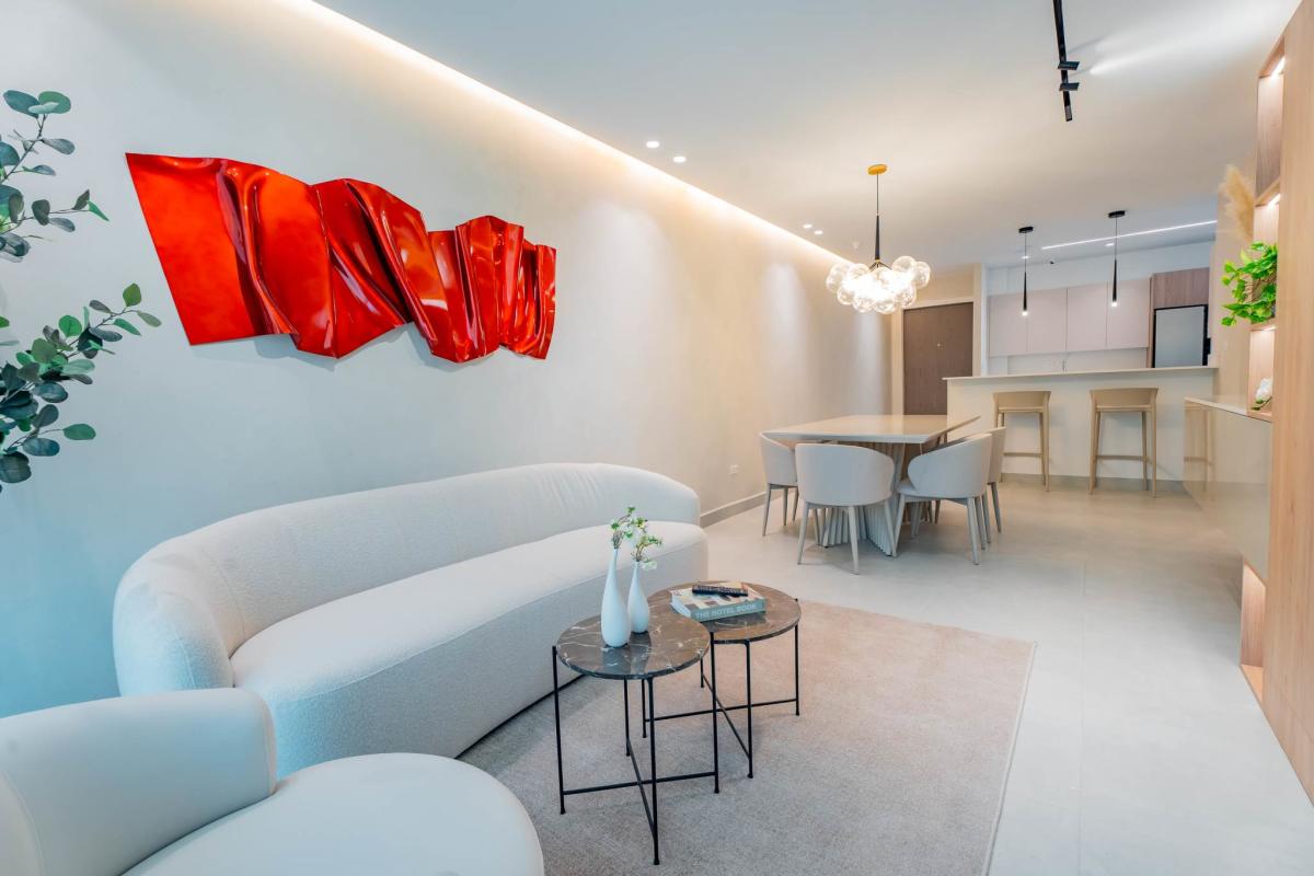 Bright living area with wood accents, large windows, minimalist furniture at Condado Gardens Panama City