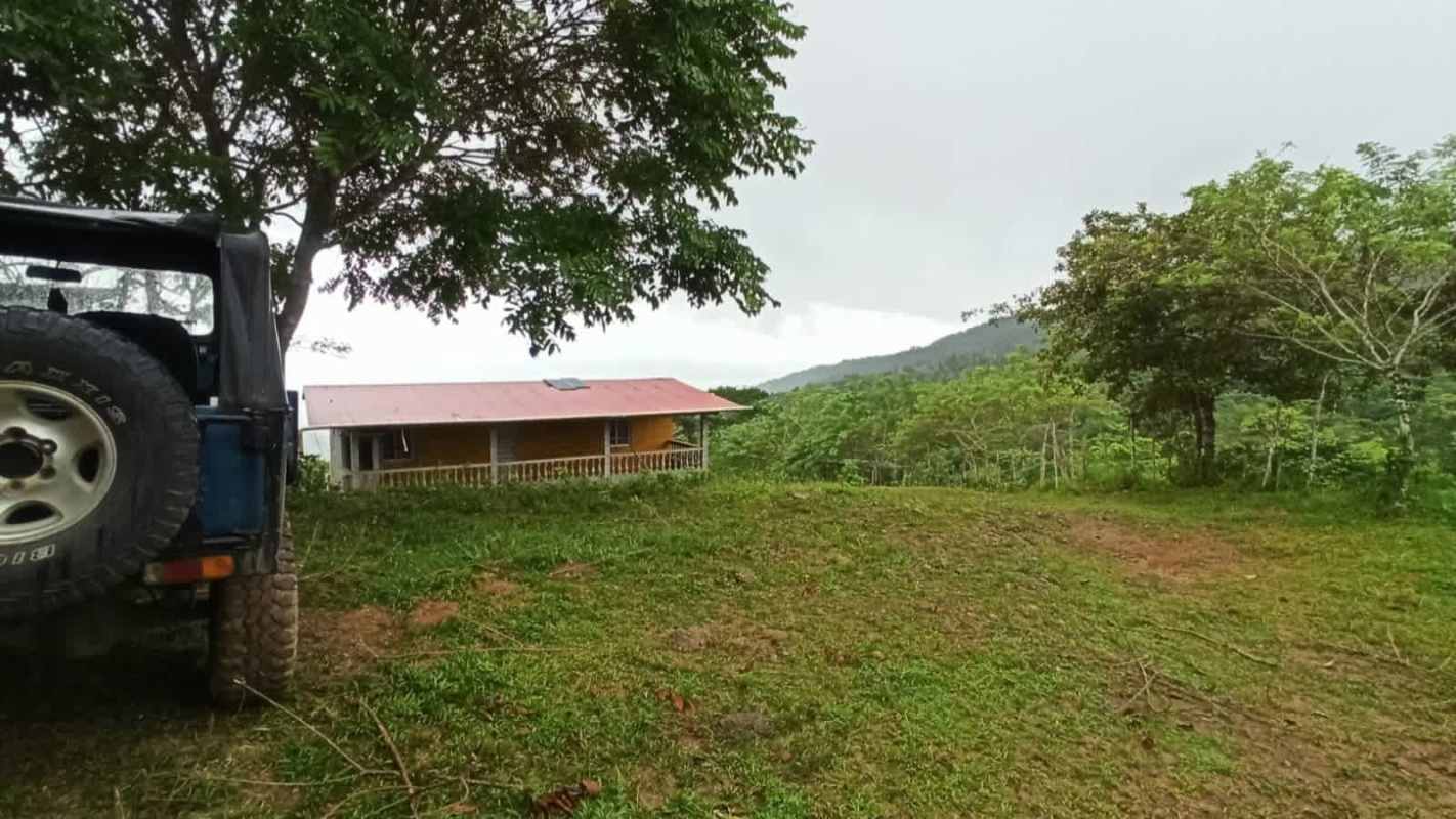 Wooden rustic country home with porch and red metal roof in Las Margaritas Chepo Panama