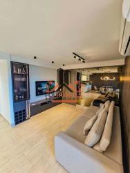 Open-concept modern living room with kitchen area in PH Explora Howard