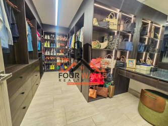 Spacious modern walk-in closet with vanity in PH Explora Howard